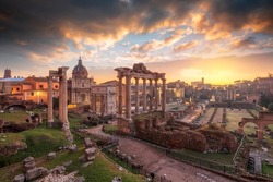 Rome, Italy at the historic Roman Forum ruins at dusk.