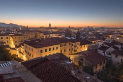 Pisa, Tuscany, Italy town skyline rooftop view at dawn.