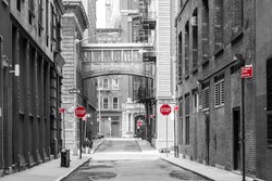 Red signs in a black and white cityscape at the intersection of Jay and Staple Streets in the Tribeca neighborhood of New York City NYC
