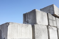 stack of concrete blocks, construction site against a blue sky