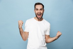 Cheerful excited man wearing blank t-shirt standing isolated over blue background, celebrating success