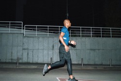 Image of a handsome strong african sports man runner at night outoors running.