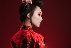 Image of attractive asian geisha woman in traditional japanese kimono isolated over red background
