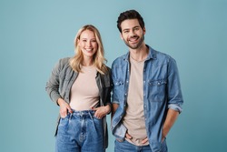 Young beautiful caucasian man and woman smiling and posing at camera isolated over blue background