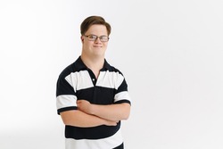 Young man with down syndrome smiling and looking at camera isolated over white background