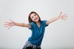 Portrait of a happy young girl with outstretched hands to embrace you isolated on a white background