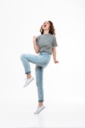 Picture of excited young caucasian lady make winner gesture isolated over white background.