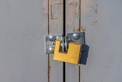 Strong Brass Padlock at Metal Storage Doors