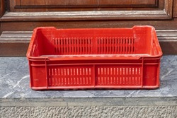 One Empty Red Plastic Crate for Produce Delivery