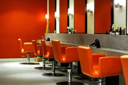 Modern empty hair saloon with chairs and mirrors