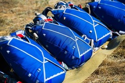 Parachutes are laid out on the ground before a skydiving competition. Parachuting