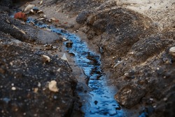 Hazardous chemicals are released into the soil. Industrial wastewater. Sewage drains into the soil. Environmental pollution. Ecological catastrophe and disaster. Contamination.