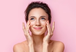 Beautiful woman with perfect skin on pink background. Beauty and skin care concept