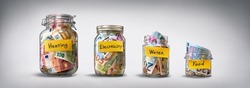 Four glass jars for savings, cash money (euro banknotes) on grey background. For utility bills: heating, electricity, water. Savings for life and food