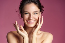 Young pretty girl with natural makeup on pink background. Beauty & Skin care concept