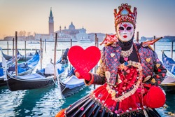 Venice, Italy, Carnival of Venice, beautiful mask at Piazza San Marco with gondolas and Grand Canal.