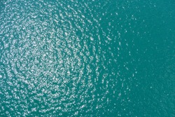 sea water smooth surface, ocean reflection sun, view above water 40 meter