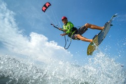 A kite surfer rides the waves