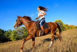 Beautiful girl riding a horse  in countryside.
