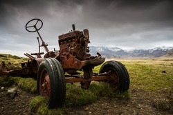 Old rusted abandoned tractor on a farm 