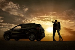 Silhouette of happiness couple stay near the new car under sky