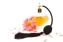 Luxurious perfume bottle atomizer with flower blossom isolated on white background. Feminine beauty concept.
