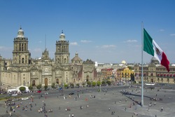 the zocalo in mexico city, with the cathedral and giant flag in the centre