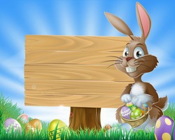 A cute Easter bunny rabbit character standing by a wooden sign holding a basket of decorated Easter eggs surrounded by Easter eggs in a field