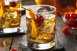 Homemade Old Fashioned Cocktail with Cherries and Orange Peel