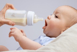 baby infant eating milk from bottle