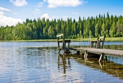 Dock or pier on lake in summer day. Finland