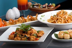 A big assortment of Thai foods and appetizers presented beautifully with fancy garnish.