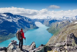 Traveler with backpack and mountain panorama. Norway