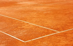 Clay tennis court. Surface outside back and side lines. Diagonal View.
