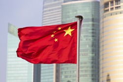 China's flag on the background of skyscrapers of Shanghai World Financial Center 