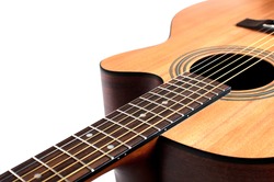 Wooden acoustic guitar isolated closeup horizontal