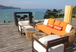 orange sofa and the colorful pillows  with the sea view in a luxury resort 