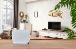 Modem and router box on the table and living room background blur concept.