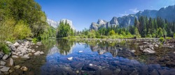 Panoramic view of famous Yosemite Valley with beautiful Merced river on a scenic sunny day with blue sky in summer, Yosemite National Park, California, USA