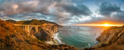 Scenic panoramic view of historic Bixby Creek Bridge along world famous Highway 1 in beautiful golden evening light at sunset with dramatic cloudscape in summer, Monterey County, California, USA