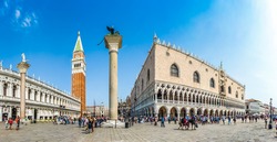 Beautiful panoramic view of historic Piazzetta San Marco with Doge's Palace and famous St Mark's Campanile and Colonne di San Marco e San Teodoro on a sunny day with blue sky, Venice, Italy