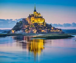 Beautiful view of famous Le Mont Saint-Michel tidal island in beautiful twilight during blue hour at dusk, Normandy, northern France