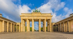Classic view of famous Brandenburg Gate, one of the best-known landmarks and national symbols of Germany, in beautiful golden morning light at sunrise in summer, central Berlin, Germany