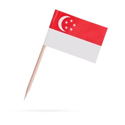Miniature paper flag Singapore. Isolated Singaporean toothpick flag stick on white background. With shadow below.