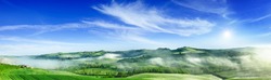Panorama, Italian beautiful landscape, foggy rolling fields of Tuscany in light of the rising sun