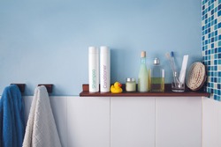 Blue wall and a shelf in the bathroom with hygiene accessories
