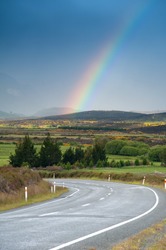 Beautiful landscape of road and rainbow in blue sky, South Island, New Zealand