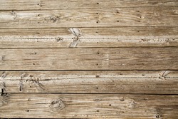 Old, worn and sandy beach planks on a boardwalk
