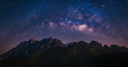 Nature landscape view of mountain range with universe space of milky way galaxy and stars on night sky