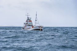 fishing boat in the open cold sever ocean
